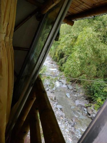 a view of a river from a window of a house at Hospedaje Rural Tupinamba in Ibagué