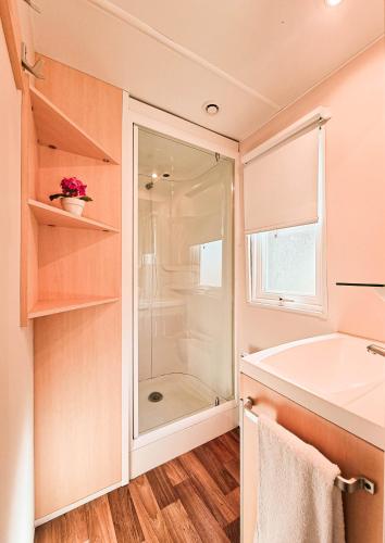 a bathroom with a shower and a tub and a sink at Bungalow Maite in L'Escala