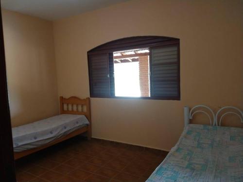 En eller flere senger på et rom på Chácara recanto da família