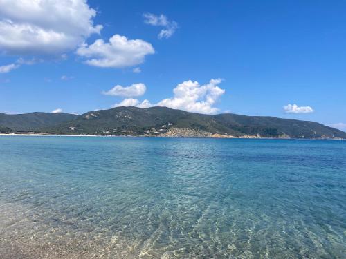 a view of the ocean with mountains in the background at Moonlight Apartament in Campo nell'Elba