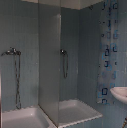 a bathroom with a shower with a tub and a sink at Rafting & Via Ferrata Base Camp in Vadul lui Carol II