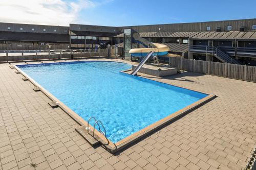 a large swimming pool on top of a building at Landal Hotel Fyrklit in Hirtshals