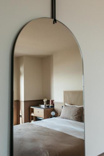 a bedroom with a large bed and a desk at Port Hotel in Eastbourne