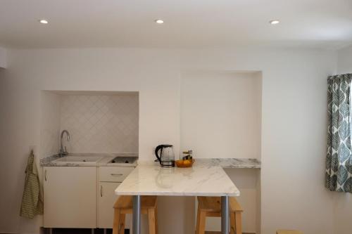 a kitchen with a sink and a counter top at Proa d'Alfama Guest House in Lisbon
