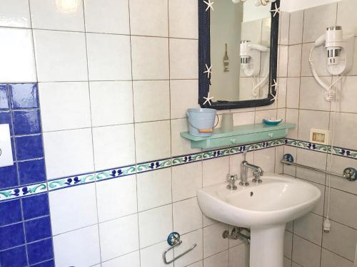 a bathroom with a sink and a mirror at PonzaSmeralda Le Forna in Ponza