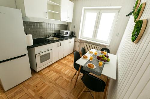 a small kitchen with a table with fruit on it at WillaMaks in Ustka