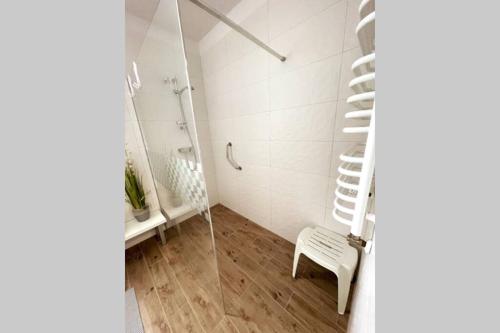 a bathroom with a white staircase and a white chair at Modern apartment in Tarnow in Tarnów