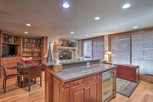 a large kitchen with a table and a fireplace at Updated Condo Walk to Vail Village and Ski Shuttle! in Vail