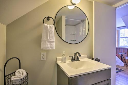 a bathroom with a sink and a mirror at Raleigh ITB Home - Mins to Downtown and North Hills! in Raleigh