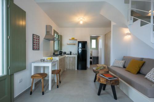 a small living room with a couch and a kitchen at Oia Kissiri - Private Pool Villas in Oia