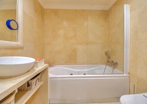 a bathroom with a tub and a sink at Casa D'Olga in Lagos