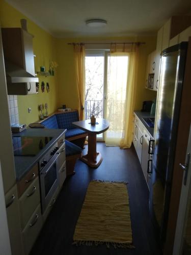 a kitchen with a table and a small table in it at Apartment Graz Lustbuhel in Graz
