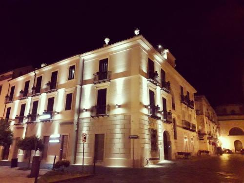 a large white building with lights on it at night at La Locanda del Baffo in Capua