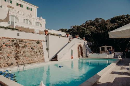 a swimming pool in front of a building at Villa Parisi Grand Hotel in Castiglioncello