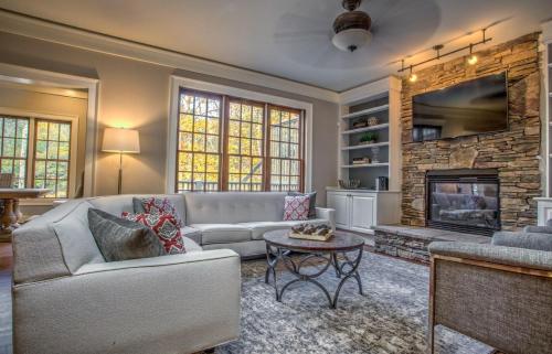 a living room with a couch and a fireplace at Hidden Creek Lodge in Asheville