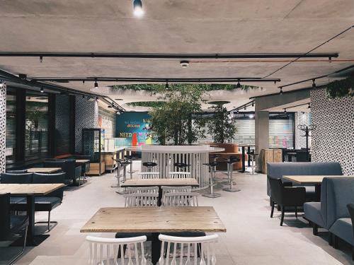 a restaurant with wooden tables and chairs and tables at IQ Hotel in Kyiv