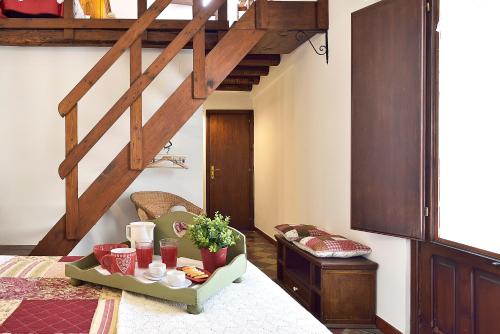 a room with a staircase and a table with a tray of food at Case del Vicolo Stretto in Modica