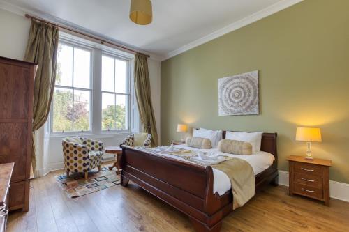 a bedroom with a large bed and a large window at No32 Hotel in Edinburgh