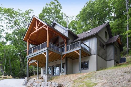 a house on top of a hill with trees at Rustic Timber in Montreat