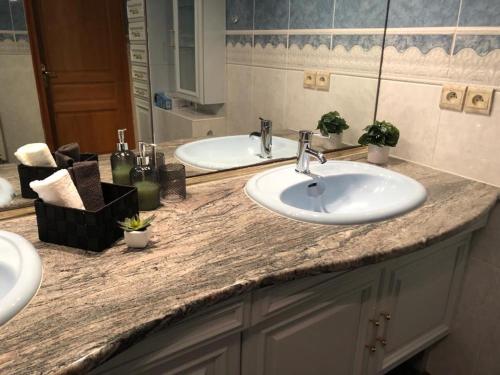 a bathroom counter with two sinks and a mirror at Villa del catalunya in Perpignan