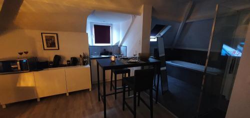 a small kitchen with a table and chairs in a room at La Belle Mosane de La Plante in Namur