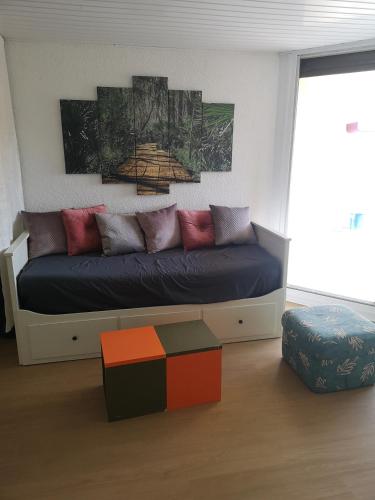 a living room with a couch with colorful pillows at T2, VUE sur MER, TERRASSE, Parking Privé in Le Barcarès