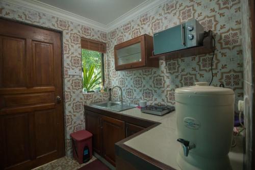 a kitchen with a mixer in the corner of a room at Deserenity in Seremban