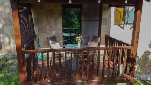 a balcony with a table with two laptops on it at De Serenity - Exclusive Jungle Retreat in Seremban
