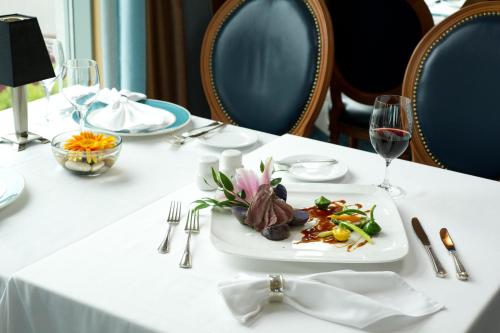 a white table with a plate of food on it at The Waterside Inn in Mississauga