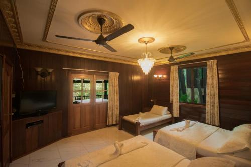 a bedroom with two beds and a ceiling fan at De Serenity - Exclusive Jungle Retreat in Seremban