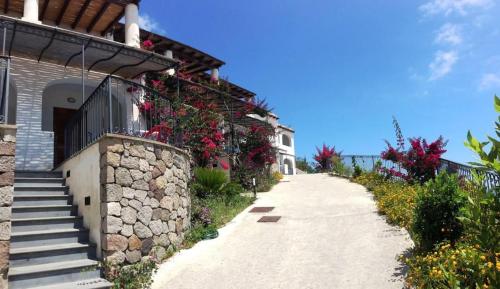 a pathway next to a house with flowers at Oltremare Residence Hotel in Lipari