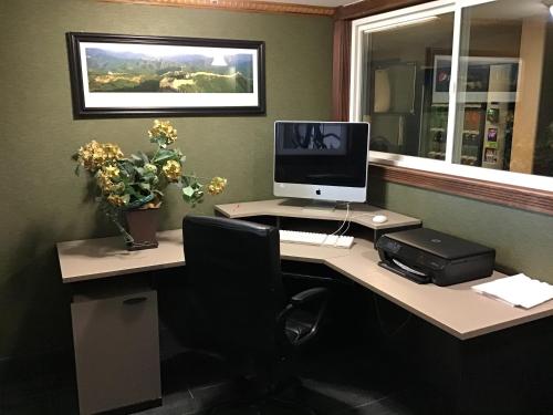 an office with a desk with a computer on it at Howard Johnson by Wyndham Gillette in Gillette