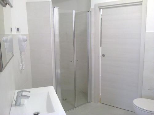 a shower in a bathroom with a toilet and a sink at B&B The Secret Place in Cavedago