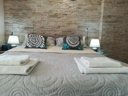 a bedroom with a large bed with pillows on it at Cichy Zakątek in Wilkasy
