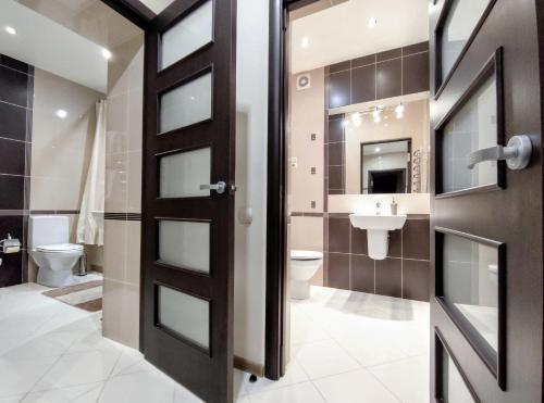 een badkamer met een zwarte deur en een wastafel bij Positive in Lviv