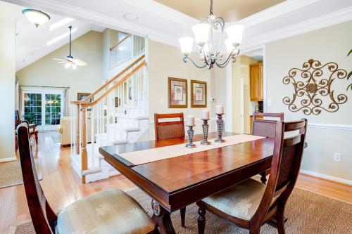 a dining room with a wooden table and chairs at Bayside Bethany Lakes - S Mill #177 in Ocean View