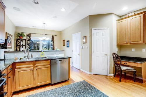 a kitchen with wooden cabinets and a sink at Bayside Bethany Lakes - S Mill #177 in Ocean View