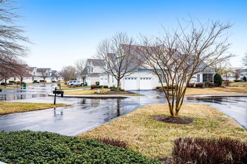 a flooded street in a residential neighborhood with a tree at Bayside Bethany Lakes - S Mill #177 in Ocean View