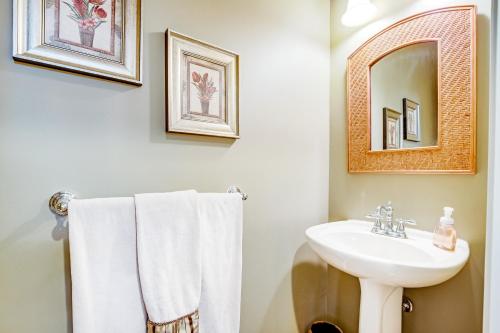 a bathroom with a sink and a mirror and towels at Bayside Bethany Lakes - S Mill #177 in Ocean View