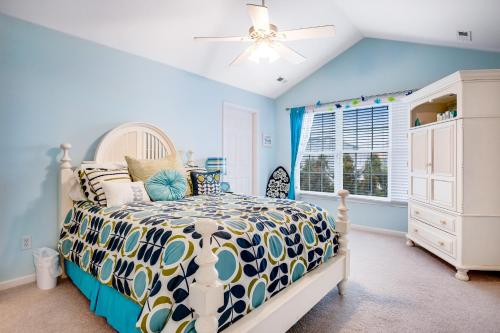 a bedroom with a bed and a ceiling fan at Bayside Bethany Lakes - S Mill #177 in Ocean View