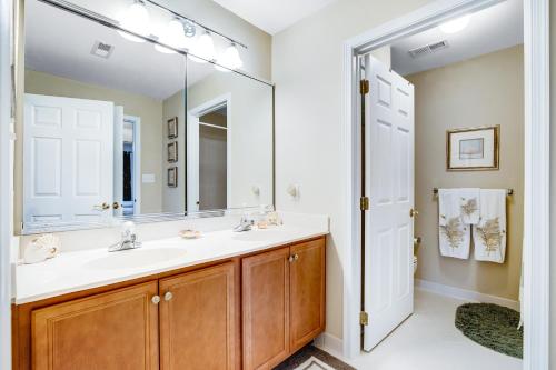 a bathroom with a sink and a mirror at Bayside Bethany Lakes - S Mill #177 in Ocean View