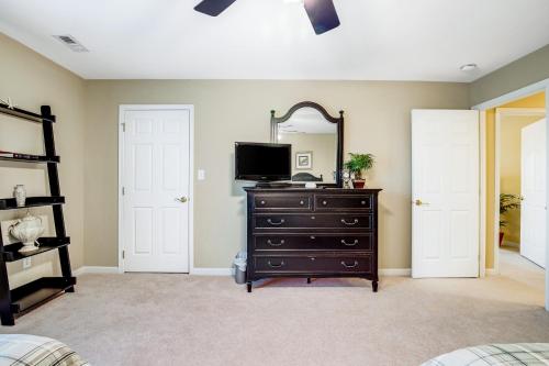 a bedroom with a dresser and a mirror at Bayside Bethany Lakes - S Mill #177 in Ocean View