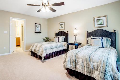 a bedroom with two beds and a ceiling fan at Bayside Bethany Lakes - S Mill #177 in Ocean View