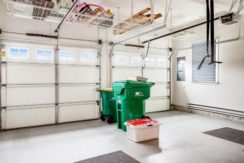 a garage with two garage doors and two trash cans at Bayside Bethany Lakes - S Mill #177 in Ocean View