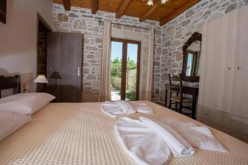 a bedroom with a large bed with white towels on it at Sivas Villa 2 in Sívas