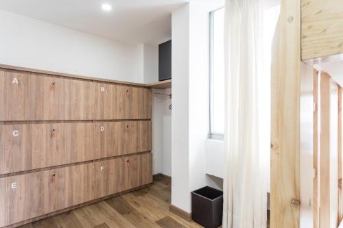 a room with wooden cabinets and a window at Hotel Florencia Plaza in Medellín