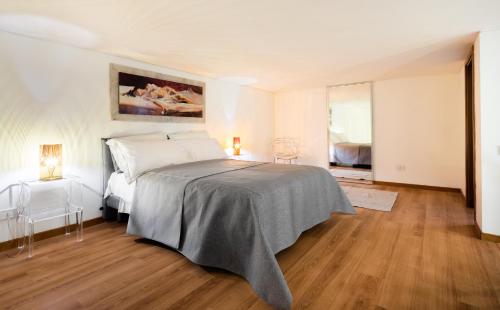 a bedroom with a large bed and a wooden floor at Rotonda 23 - Loft in Pantheon in Rome