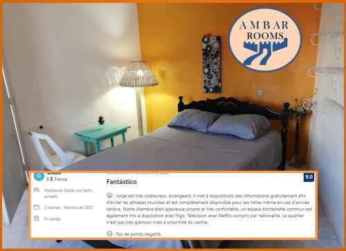 a homepage of a bedroom with a bed and a desk at AMBAR Rooms in Campeche