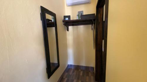 a mirror on a wall next to a hallway at Estancita Elena in Valle de Guadalupe