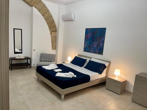 a bedroom with a bed with two towels on it at Le Gemme in Castellammare del Golfo